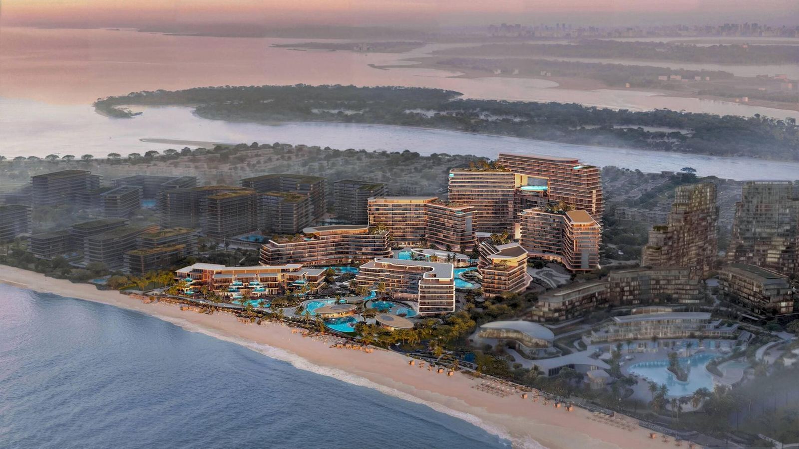 Aerial view over the pools and beachfront at golden hour